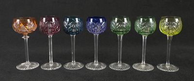 six different colored wine glasses lined up in a row