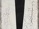 a black and white picture of a cross painted on a wall
