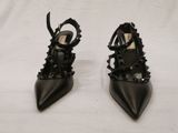 black high heeled shoes with spikes on the toes