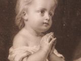 a black and white photo of a little girl holding a teddy bear