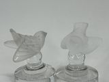 pair of clear glass bird figurines sitting on top of each other