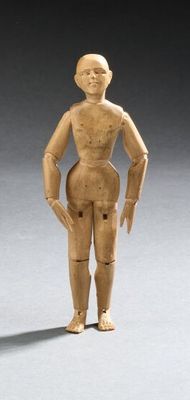 an image of a wooden doll standing in the middle of a room