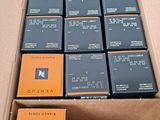 a cardboard box filled with many different types of cigarettes