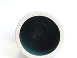 a black and white vase sitting on a white surface