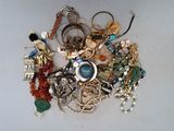 un tas de bijoux posés sur une table, sur fond blanc
