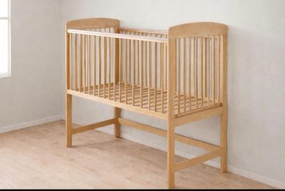 un lit d'enfant dans un coin de la pièce, près d'une fenêtre