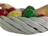 a white basket filled with different types of fruits and vegetables
