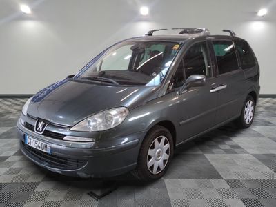 a picture of a grey car parked in a garage