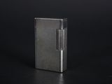 a silver lighter sitting on top of a black surface