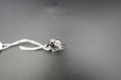 a silver ring with a blue stone on it