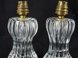 two clear glass salt and pepper shakers with gold tops
