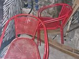 two red chairs in the corner of a room