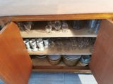 a cabinet with a lot of dishes and cups on it