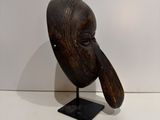 an image of a wooden sculpture of an elephant ' s head on a stand