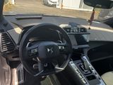the interior of a car with a steering wheel and dashboard controls