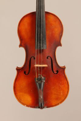 an old violin with a bow hanging from it ' s back