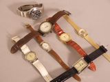 several different types of watches are displayed on a white surface