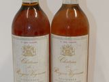 two bottles of wine sitting next to each other on a table