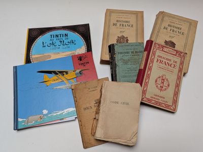 several old books sitting on top of a table next to each other