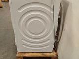 an image of a white washing machine in a warehouse