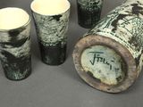 five cups sitting next to each other on a table