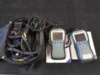 three cell phones in a bag on the floor