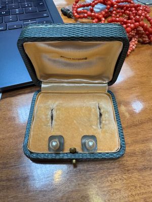 an open case with two pairs of earrings inside of it