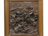 une image représentant un relief en bronze d'un groupe d'hommes à cheval