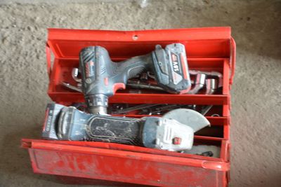 a red box with tools in it on the floor
