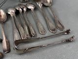 a lot of silver spoons and spoon spoons on a table