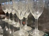 many wine glasses sitting on a glass table