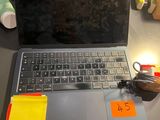 a laptop computer sitting on a desk with sticky notes on it