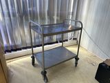 a metal cart that is sitting in front of a window