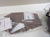 a bag of clothing sitting on a table next to a computer