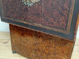 a wooden cabinet with a metal handle on a wooden floor