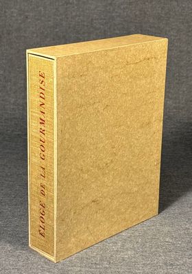 a brown book sitting on top of a table next to a gray wall