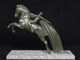 statue of a horse with a long mane on a marble base