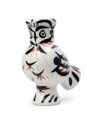 a white vase with a black and red design on it