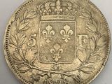 a silver coin with a crown on top of it