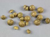 some gold coins are sitting on a table with a white background
