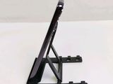 a tablet on a stand on a white surface