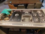 une table sur laquelle sont posés plusieurs plateaux de nourriture