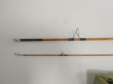 two fishing rods and a bag on a white surface