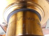a close up view of a brass telescope with a wooden case