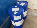 two blue barrels sitting next to each other in front of a blue door