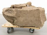 a large rock sitting on top of a wooden cart