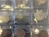a lot of coins that are in a clear box