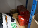 a red box sitting on a shelf next to a pile of boxes