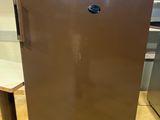 a brown refrigerator sitting in a kitchen next to a table
