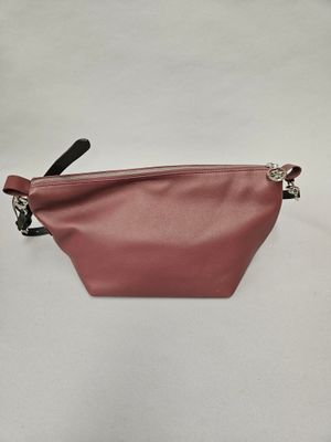 a small pink leather pouch with a black handle